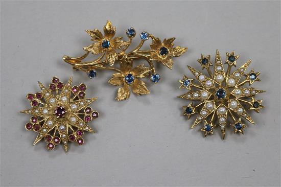 Two 9ct gold and gem set starburst brooches and a 9ct gold and gem set floral spray brooch, largest 42mm.